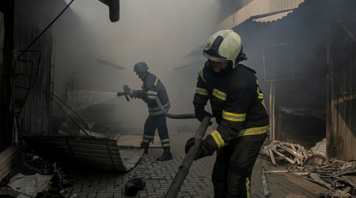 Fires are extinguished in a row of stores destroyed by shelling at a market in Sloviansk, in eastern Ukraine, July 5, 2022. Remaining residents in the depleted city's now in the cross hairs of the next Russian offensive are far from united, and many are influenced by the anti-Ukrainian propaganda spread by Russian television channels and news media in the separatist areas. (Image/The New York Times)