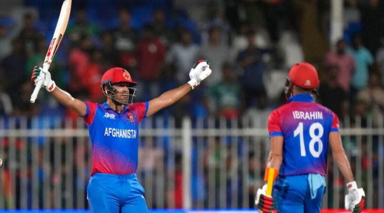 Afghanistan's Najibullah Zadran, left, celebrate after hitting wining boundary during the T20 Asia Cup cricket match between Afghanistan and Bangladesh, in Sharjah United Arab Emirates, Tuesday, Aug. 30, 2022. (AP Photo/Anjum Naveed)