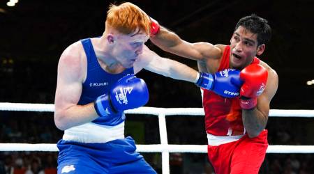 Ashish Kumar, right and England's Aaron Bowen compete in the Men's Over 75kg-80kg, Light Heavyweight quarterfinal. (AP)