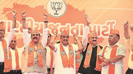 Naresh Raval and Raju Parmar with state BJP president CR Paatil on Wednesday. (Express  Photo)