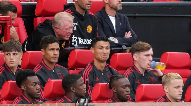 Manchester United' Cristiano Ronaldo, (centre), gestures as he sits with teammates, prior to the start of the English Premier League match between Manchester United and Brighton at Old Trafford stadium in Manchester, England. (AP)