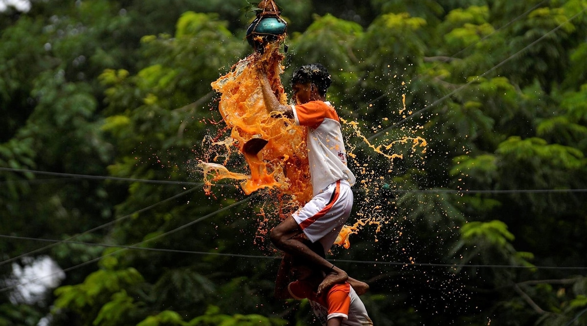 Indian youth form a human pyramid to break the "Dahi Handi," an earthen pot filled with curd, as part of celebrations to mark Janmashtami festival in Mumbai, India, August 19, 2022. (AP)