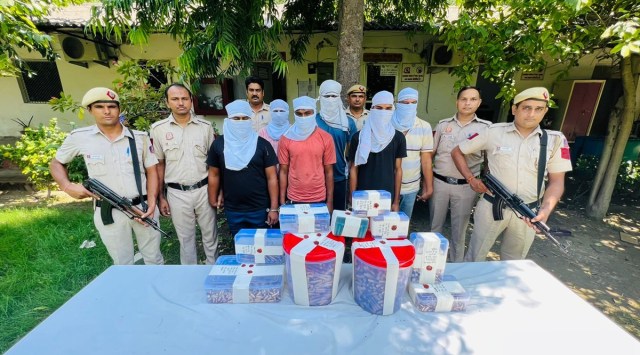 East Delhi Police with the recovered ammo and those arrested. (Express Photo)