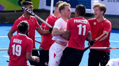 Balraj Panesar of Canada has an argument with David Goodfield of England during the hockey match between Canada and England at the Commonwealth Games in Birmingham, England. (AP)