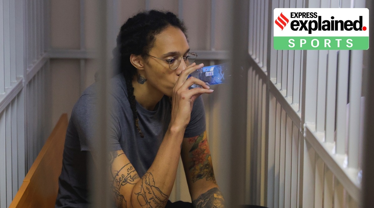 WNBA star and two-time Olympic gold medalist Brittney Griner drinks water as she listens a verdict standing in a cage in a courtroom in Khimki just outside Moscow, Russia, Thursday, Aug. 4, 2022. (Evgenia Novozhenina/Pool Photo via AP)