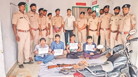 The forest officials in Dang with four poachers held for hunting a pregnant Chital deer. (Express Photo)