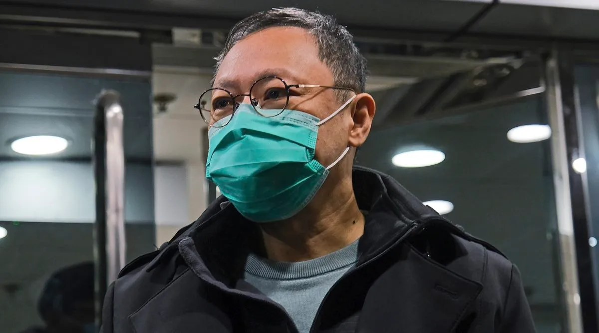 Former law professor Benny Tai, a key figure in Hong Kong's 2014 Occupy Central protests and also was one of the main organizers of the primaries, who was arrested under Hong Kong's national security law, gives the thumbs up as he is escorted by Correctional Services officers in Hong Kong March 2, 2021. A Hong Kong court began mitigation hearings for prominent pro-democracy activists who were convicted under a national security law and now face up to life in prison, 