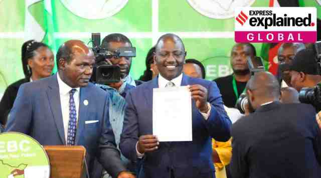 William Ruto, center, shows a certificate after the announcement of the results of the presidential race at the Centre in Bomas, Nairobi, Kenya, Monday, Aug. 15, 2022. (AP Photo/Sayyid Abdul Azim)
