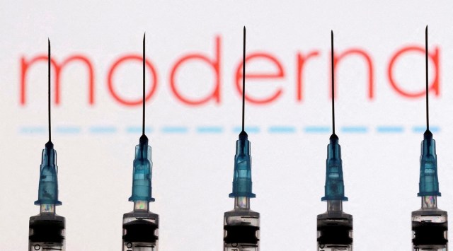 Syringes with needles are seen in front of a displayed Moderna logo in this illustration taken November 27, 2021. (REUTERS)