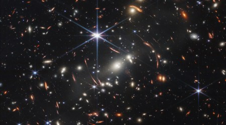 Image of a distant galaxy cluster showing a phenomenon called gravitational lensing