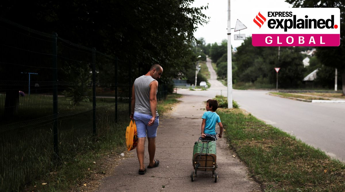 Vadim, 30, and his son talk next to an empty playground of a residential building, as Russia's invasion of Ukraine continues, in Kramatorsk, Donetsk region Ukraine August 12, 2022. (Reuters Photo: Nacho Doce)