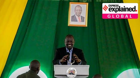 Kenya's President-elect William Ruto, stands under a photograph of current president Uhuru Kenyatta, as he prepares to address the media. (AP/File)