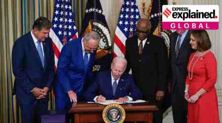 President Joe Biden signs the Democrats' landmark climate change and health care bill in the State Dining Room of the White House in Washington, Tuesday, Aug. 16, 2022, as from left, Sen. Joe Manchin, D-W.Va., Senate Majority Leader Chuck Schumer of N.Y., House Majority Whip Rep. James Clyburn, D-S.C., Rep. Frank Pallone, D-N.J., and Rep. Kathy Castor, D-Fla., watch. (AP Photo)