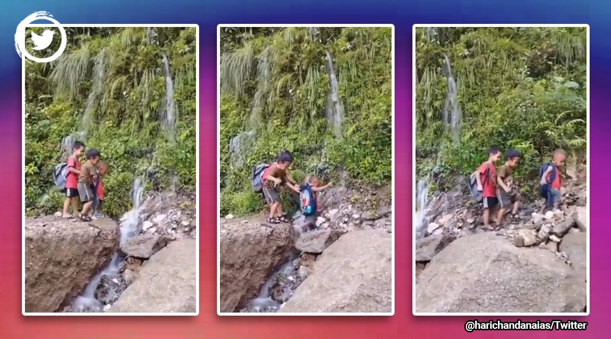 three boys going to school, three boys help to walk through rocky terrain, three boys walk through waterfall, viral video, indian express
