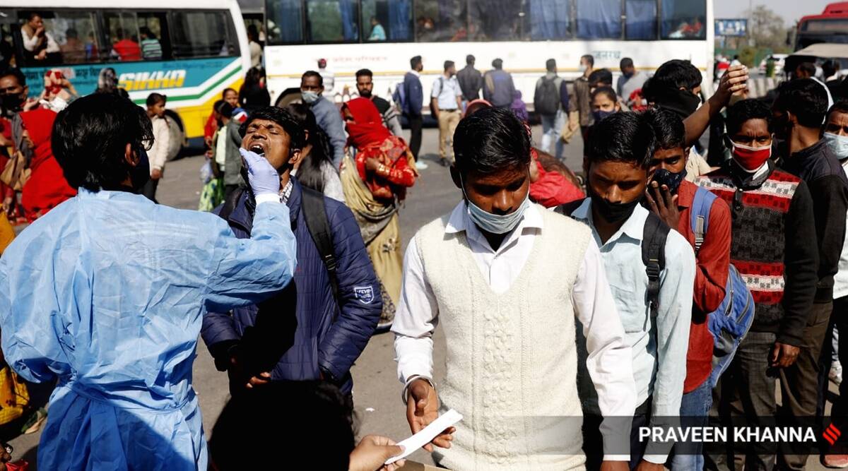 A health worker collecting swab samples for Covid-19 testing, in New Delhi. (Express Photo by Praveen Khanna/File)