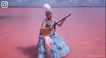 Kazakh woman, Kazakh woman plays dumbrya, pink coloured lake, Erik Solheim, woman playing music in pink lake, indian express