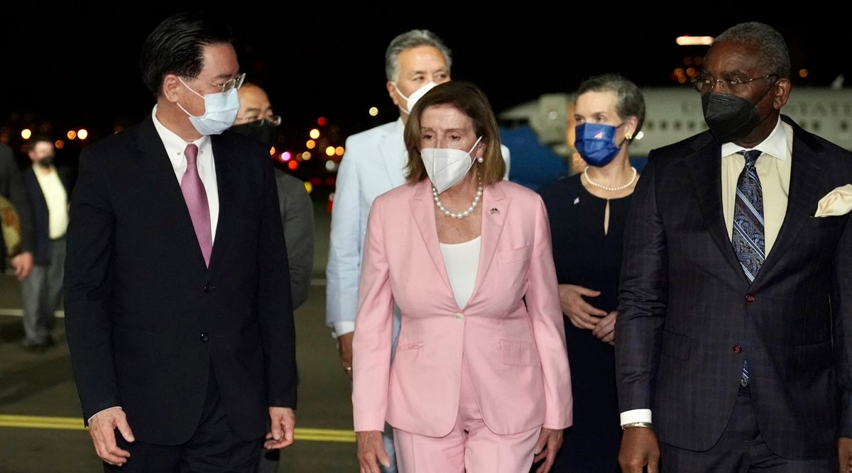 US House Speaker Nancy Pelosi, center, walks with Taiwan's Foreign Minister Joseph Wu, left, as she arrives in Taipei, Taiwan, Tuesday, Aug. 2, 2022. (Taiwan Ministry of Foreign Affairs via AP)