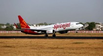 SpiceJet flyers walk on Delhi airport's tarmac after waiting for bus