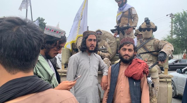 Taliban fighters gather in Kabul to mark a year since their takeover of Afghanistan, on Monday. (Express Photo by Nirupama Subramanian)