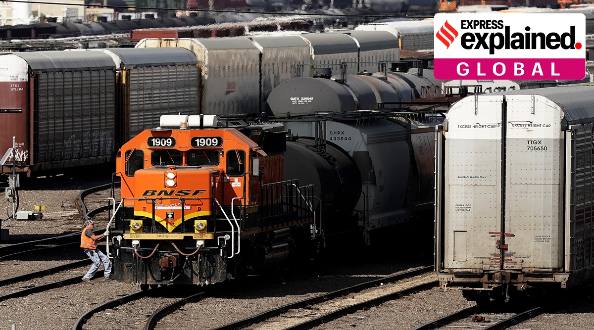 A worker boards a locomotive at a BNSF rail yard Wednesday, Sept. 14, 2022, in Kansas City, Kan. (AP Photo/Charlie Riedel)