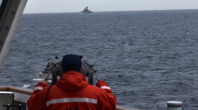 In this photo provided by the US Coast Guard, a Coast Guard Cutter Kimball crew-member observes a foreign vessel in the Bering Sea, Sept 19, 2022. (US Coast Guard District 17 via AP)