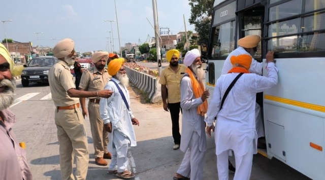 Protesters board the police bus that remains stationed near the Bargari gurdwara. Express
