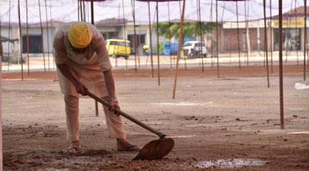 A member of BKU Ugrahan  readies the grain market in Barnala a day before the rally on Tuesday. (Express photo)