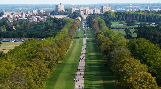People make their way along the Long Walk towards Cambridge gate outside Windsor Castle to lay flowers for the late Queen Elizabeth II in Windsor, England, Sunday, Sept. 18, 2022. The Queen will lie in state in Westminster Hall for four full days before her funeral on Monday Sept. 19. (AP Photo/Gregorio Borgia)