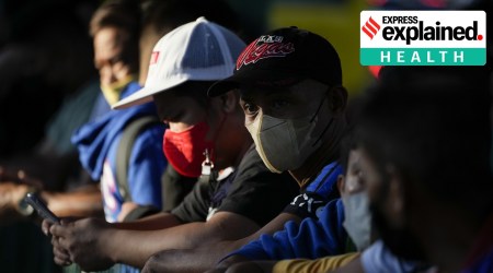 A man wearing face mask waits for a ride at a bus stop in Manila, Philippines Thursday, Sept. 8, 2022.  (AP Photo/Aaron Favila)