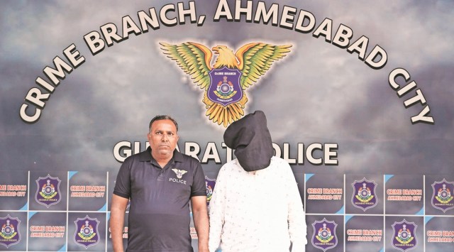 A crime branch official with the arrested man. (Express Photo)