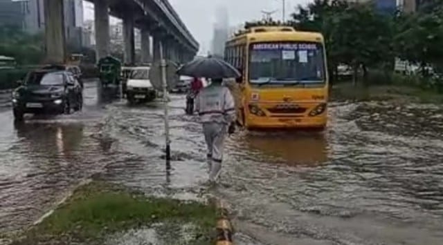 Vehicles wade through a waterlogged street in Gurgaon on Thursday. (Express Photo)