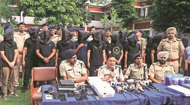 IGP Chandigarh R K Singh and other police officers address the media with some of the accused at Cyber Police Station in Sector 17, Chandigarh, on Monday. (Express Photo)