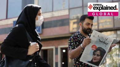 man and woman reading newspaper in Iran