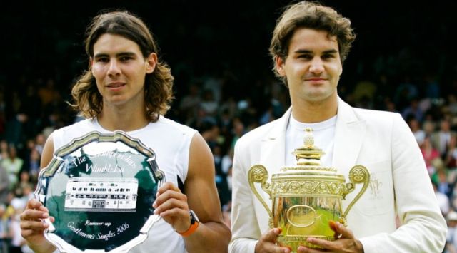 Defending champion Roger Federer, right, holds the winners trophy with runner up Rafael Nadal of Spain after the Men's Singles final on the Centre Court at Wimbledon, Sunday July 9, 2006. Federer won the match 6-0, 7-6, 6-7, 6-3. (AP Photo/Anja Niedringhaus, File)