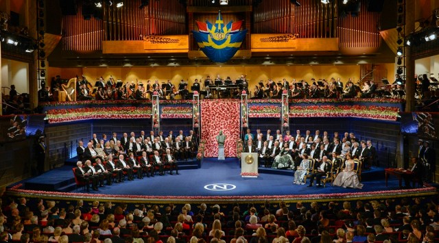 The ten 2016 Nobel laureates in literature, medicine, chemistry, physics and economics are seated, front row left, across from King Carl XVI Gustaf of Sweden and the royal family during the 2016 Nobel prize award ceremony at the Stockholm Concert Hall on Saturday Dec. 10, 2016. (AP/File)