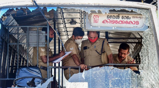 Police personnel take stock of the damages done to a Kerala State Road Transport Corporation bus after some miscreants threw stones on it, during the 'hartal' called by Popular Front of India (PFI) in protest against the nationwide arrest of its leaders by National Investigation Agency and Enforcement Directorate, in Thiruvananthapuram on Friday. (PTI/file)