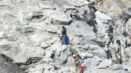 ITBP and Army personnel retrieve the body of a trekker from a crevasse at Khimloga Pass. The body was carried on stretcher for more than 20 km on foot since yesterday and was handed over to police in Chitkul, Himachal Pradesh. (PTI Photo)