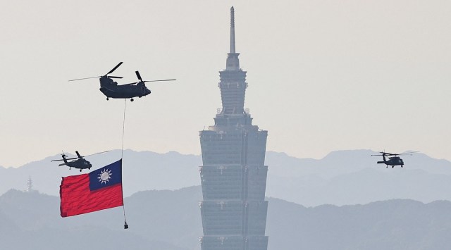A CH-47 carries a Taiwan flag fly across the city as rehearsal ahead of Taiwan National Day celebrations in Taipei. (Reuters)