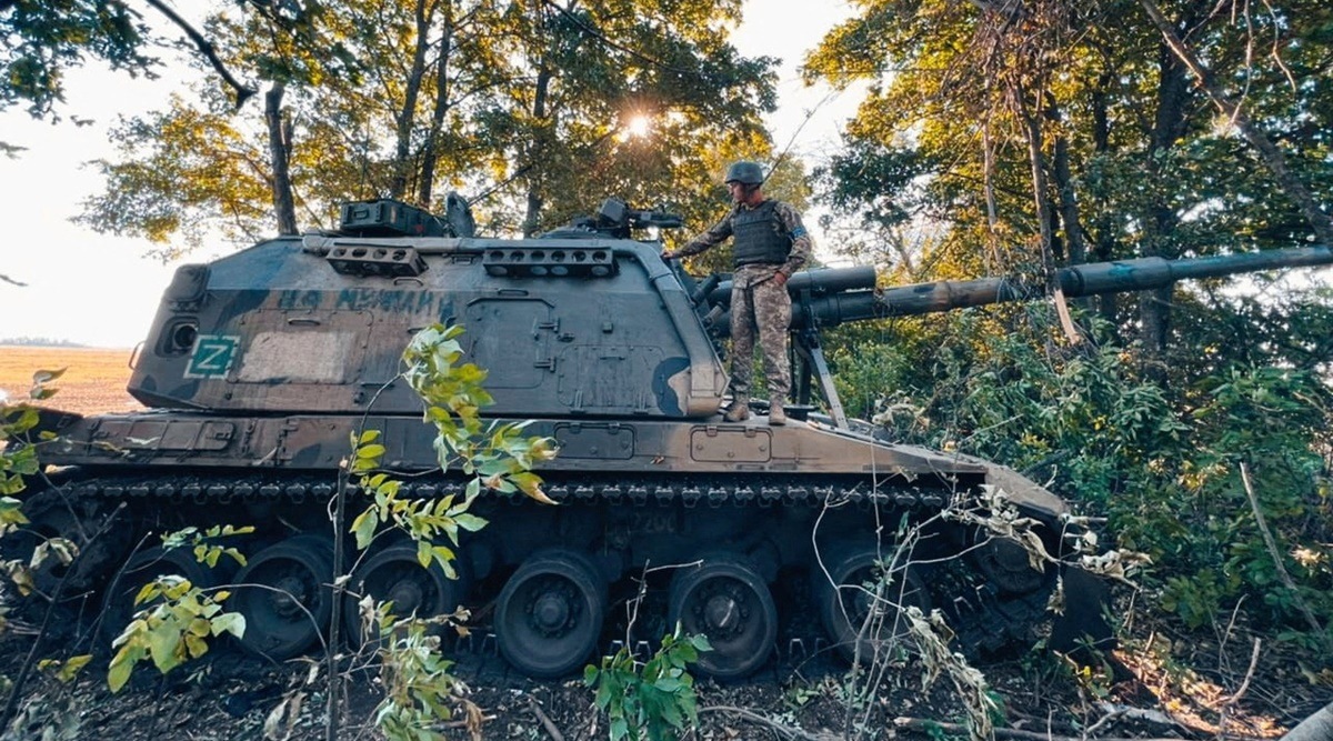 
A Ukrainian service member stands on a Russian 2S19 Msta-S self-propelled howitzer captured during a counteroffensive operation, amid Russia's attack on Ukraine, in Kharkiv region, Ukraine. (Press service of the 25th Airborne Brigade of the Armed Forces of Ukraine/Handout via Reuters)