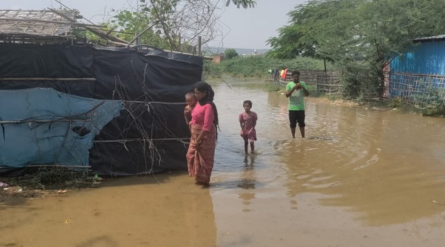 On Wednesday afternoon, several people made preparations to cook meals on a makeshift stove on top of bricks, using a gas cylinder, in the open at the camp, which has over 65 shanties. (Express photo)