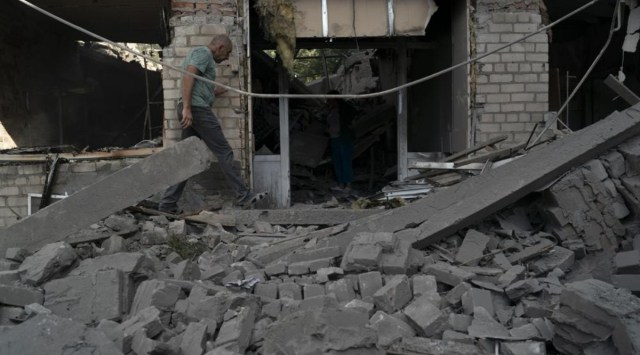 A man walks over debris of a psychiatric hospital that was heavily damaged after a Russian attack in Kramatorsk, Ukraine, Wednesday, Sept. 7, 2022. (AP Photo/Leo Correa)