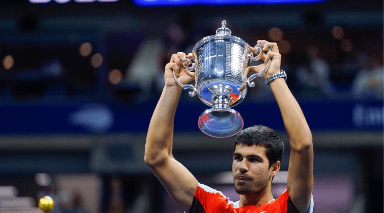Carlos Alcaraz, of Spain, holds up the championship trophy after defeating Casper Ruud, of Norway, in the men's singles final of the U.S. Open tennis championships, Sunday, Sept. 11, 2022, in New York. (AP Photo/Matt Rourke)
