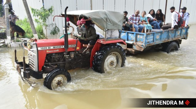 Tractors plied by local villagers, large trucks and jeeps deployed by friends and family, as well as boats provided by the fire and rescue services department have now virtually evacuated all residents of the two upscale residential properties affected by flooding in south-east Bengaluru (Express photo by Jithendra M )