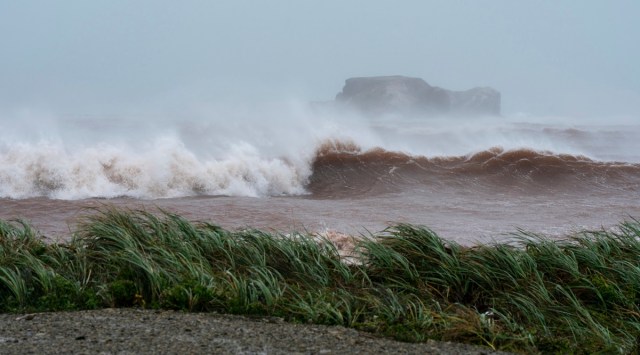 Waves coming ashore at l'Étang-du-Nord caused by post-tropical storm Fiona are shown on the Les Îles-de-la-Madeleine, Que., Saturday, Sept. 24, 2022. CStrong rain and winds are lashing the Atlantic Canada region as Fiona hits as a powerful post-tropical cyclone. (AP)