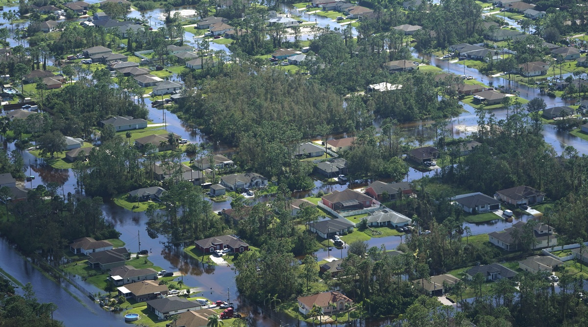 Homes are surrounded by flood waters caused by Hurricane Ian, Thursday, Sept. 29, 2022, in Fort Myers, Fla. Climate change added at least 10% more rain to Hurricane Ian, a study prepared immediately after the storm shows. (AP Photo)