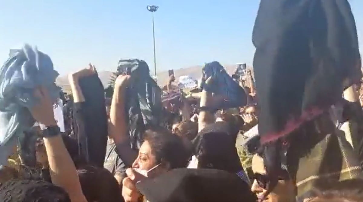 Women protestors remove their hijabs during the protest. (Twitter/
Masih Alinejad)