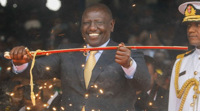 Kenyas President William Ruto displays the special sword that he received to represent his instruments of power and authority from his predecessor Uhuru Kenyatta after his official swearing-in ceremony at Moi International Stadium Kasarani in Nairobi, Kenya September 13, 2022. (Photo Courtesy: REUTERS/Baz Ratner)