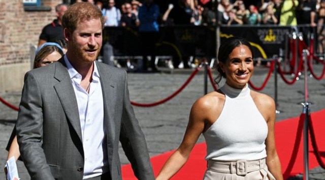 Britain's Prince Harry and Meghan, Duchess of Sussex, walk in front of the City Hall as they attend the event 'One year to go' ahead of the 2023 Invictus Games in Duesseldorf, Germany (Source: Reuters)
