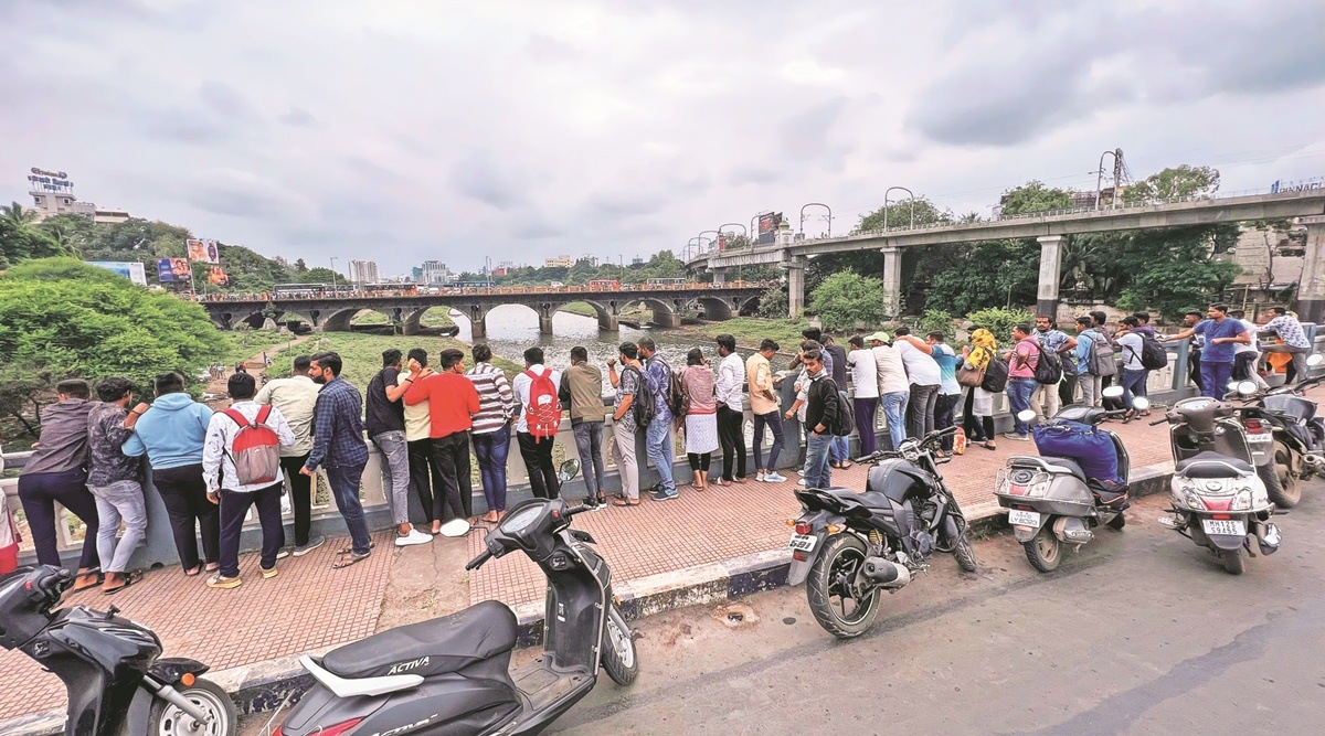 Onlookers at Baba Bhide bridge on Monday. The body was found near the bridge.  (Express Photo by Arul Horizon)