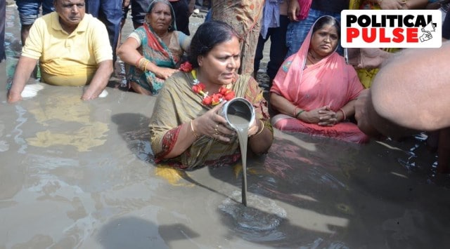 Mahagama legislator sits in the pothole filled with muddy water. (Express Photo)